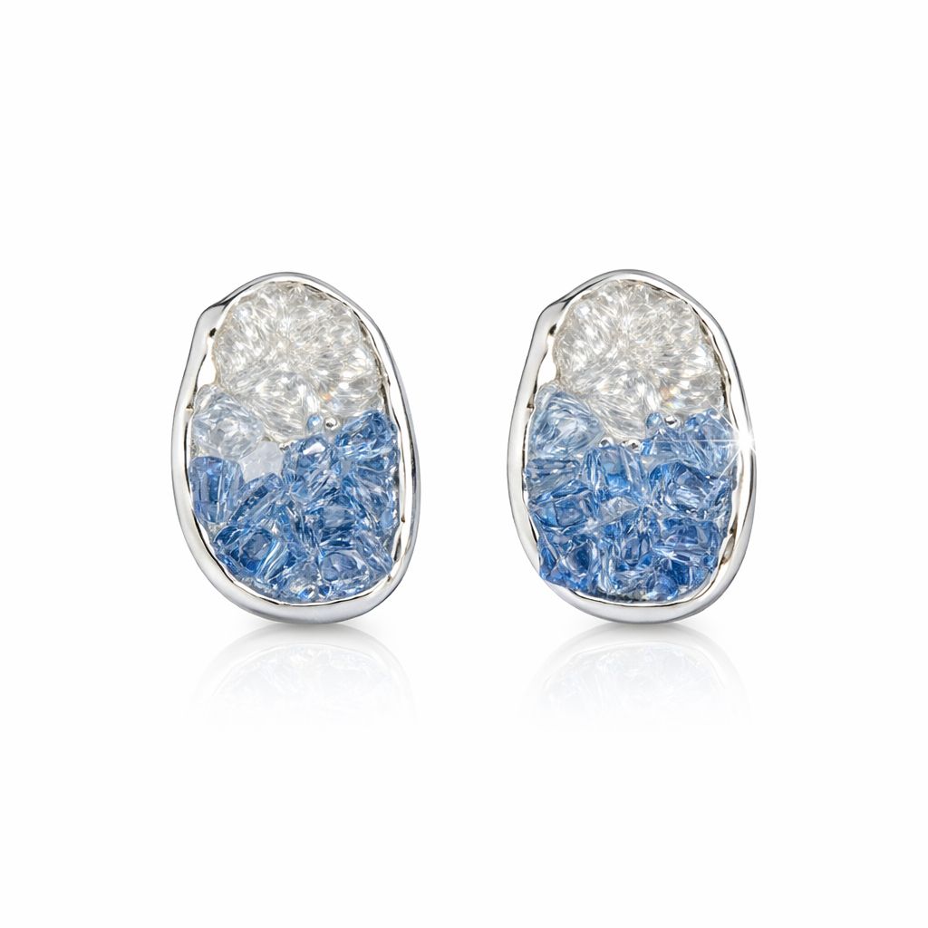 Pair of earrings with blue and clear stone design on a white background