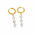Gold hoop earrings with clear zircone on a white background