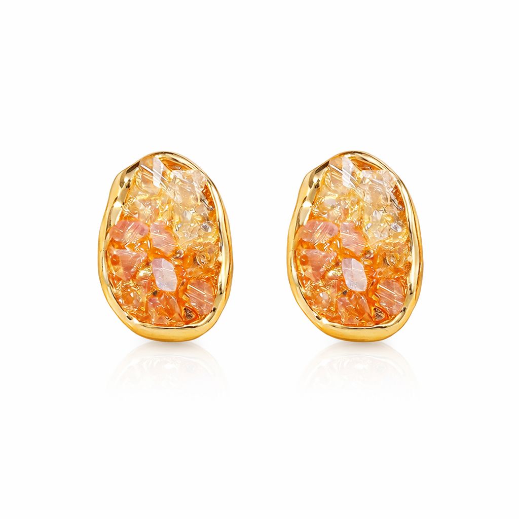 Gold-framed earrings with orange and clear stone design on a white background
